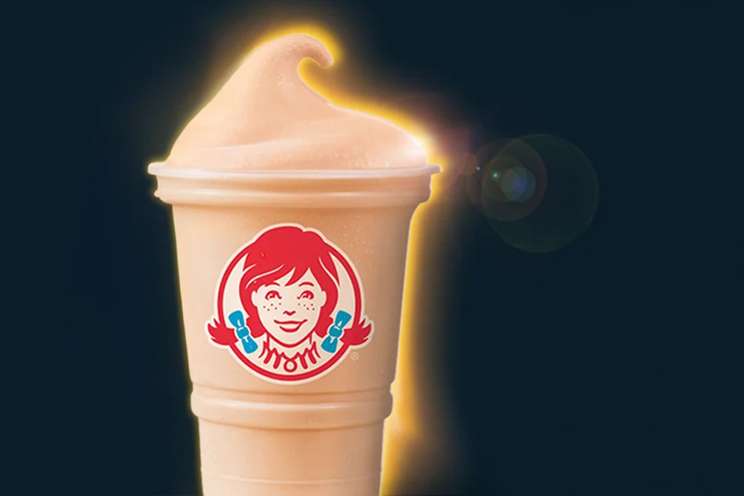 A photo composite of a Wendy's Frosty as the sun during an eclipse.